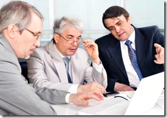 Portrait of three businessmen at the computer.